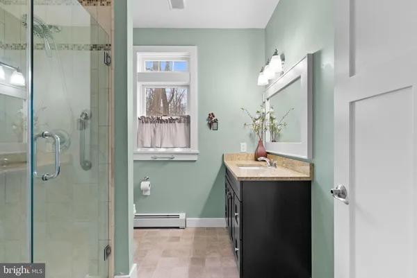 a bathroom with a sink double vanity and shower