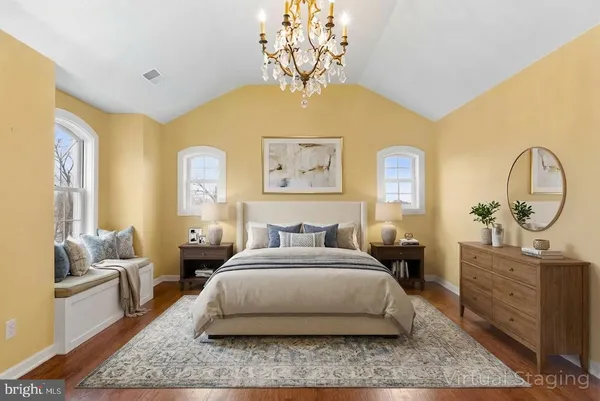 a bedroom with a large bed and a chandelier