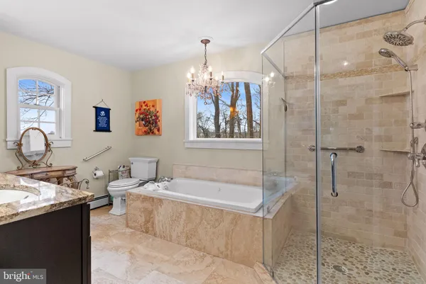 a bathroom with a tub sink and mirror