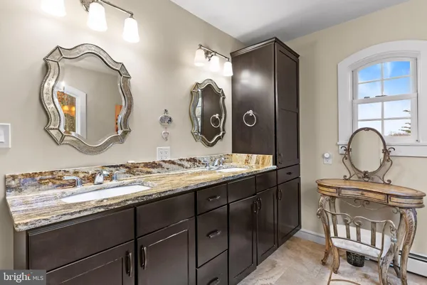 a bathroom with a double vanity sink and a mirror