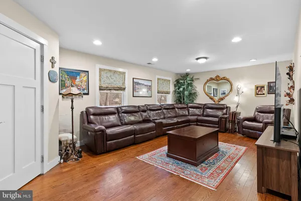 a living room with furniture a rug and a window