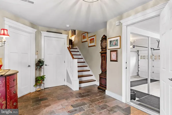 a view of a hallway with entryway wooden floor and front door