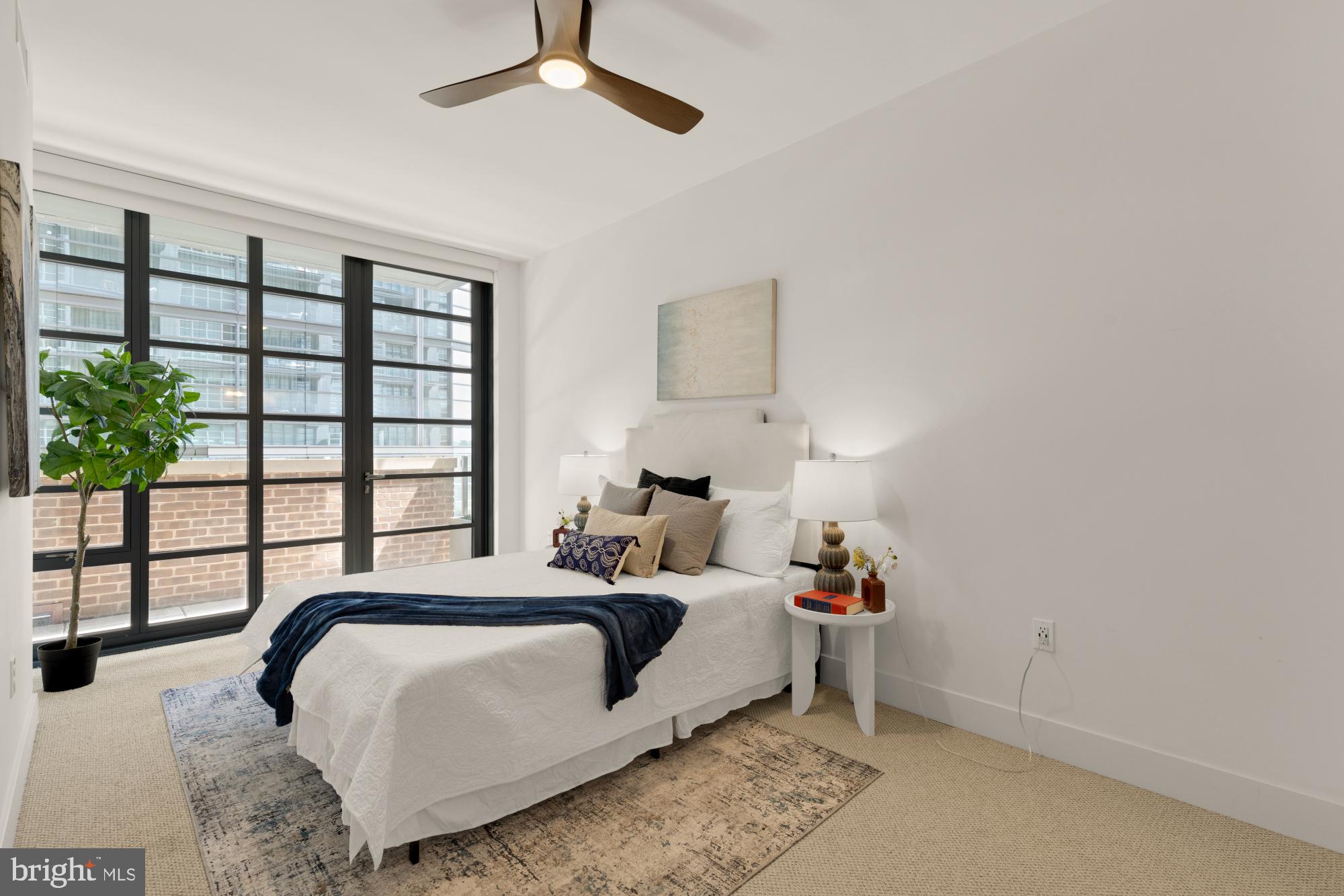 45 Sutton Square Southwest, Unit 303 Washington, DC 20024 - Photo 20 of 60 Master bedroom with a wall of windows