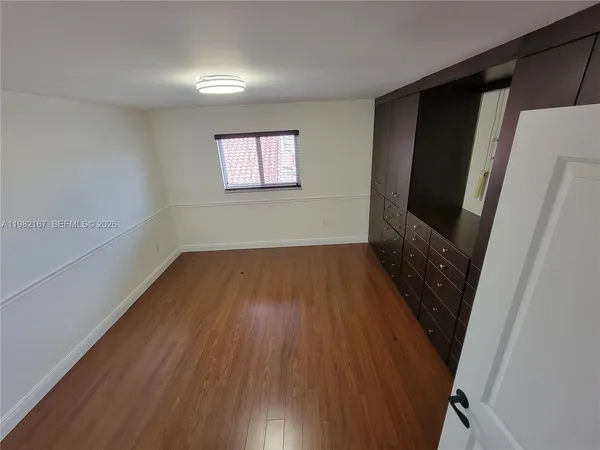 a room with a dresser and a window