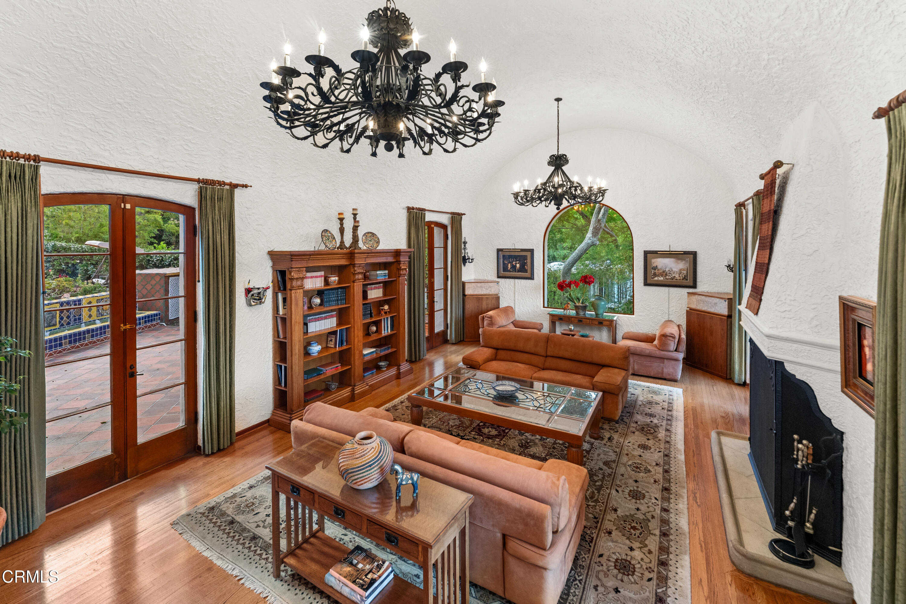 201 La Vereda Road Pasadena, CA 91105 - Photo 2 of 7 a living room with furniture a fireplace and a chandelier