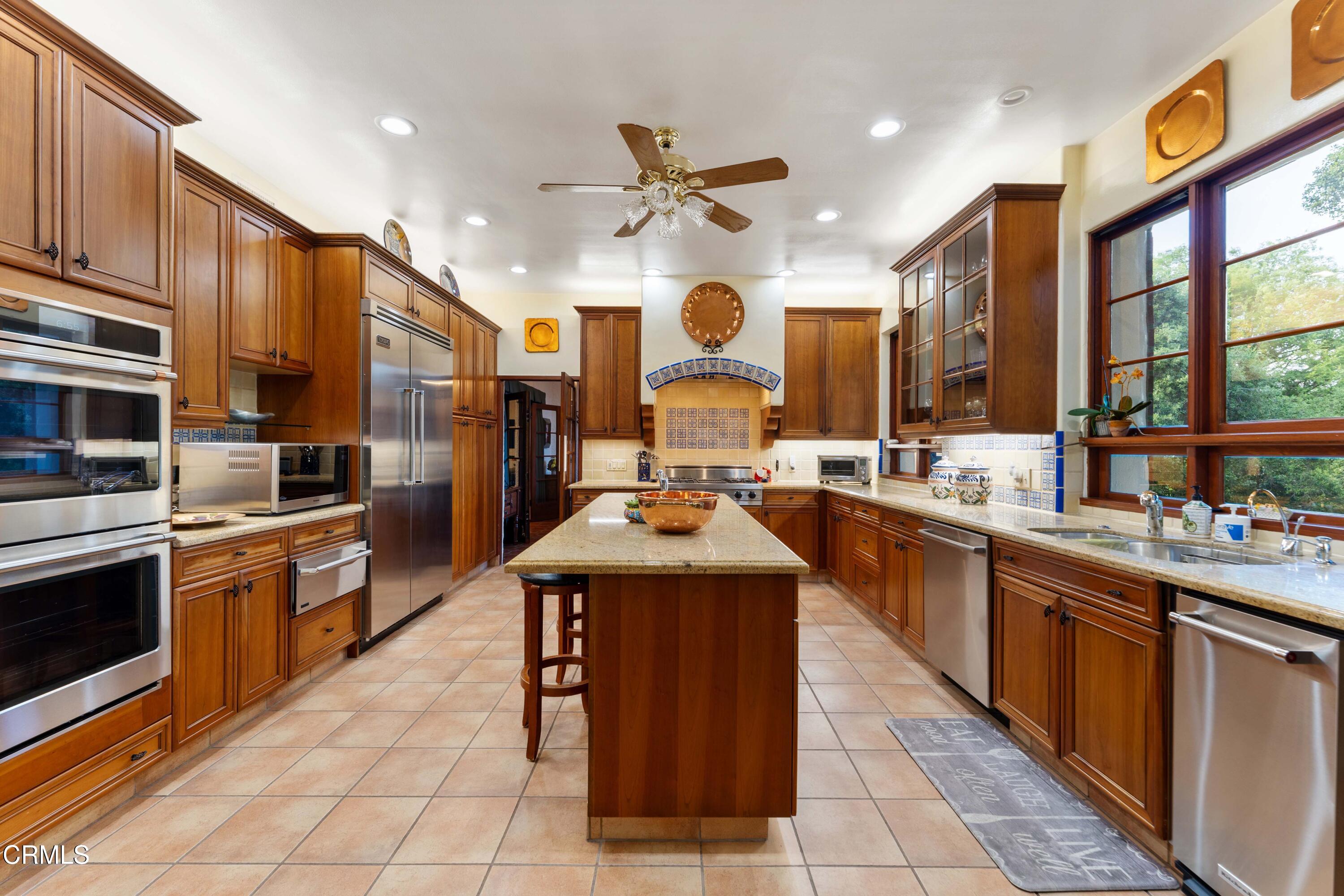 201 La Vereda Road Pasadena, CA 91105 - Photo 5 of 7 a large kitchen with stainless steel appliances granite countertop a stove and large cabinets