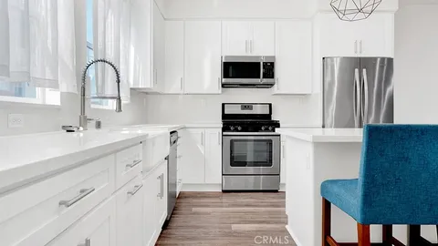 a kitchen with stainless steel appliances a stove microwave and a refrigerator