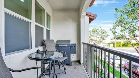 a view of a balcony with table and chairs