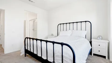 a bedroom with a large bed and a dresser