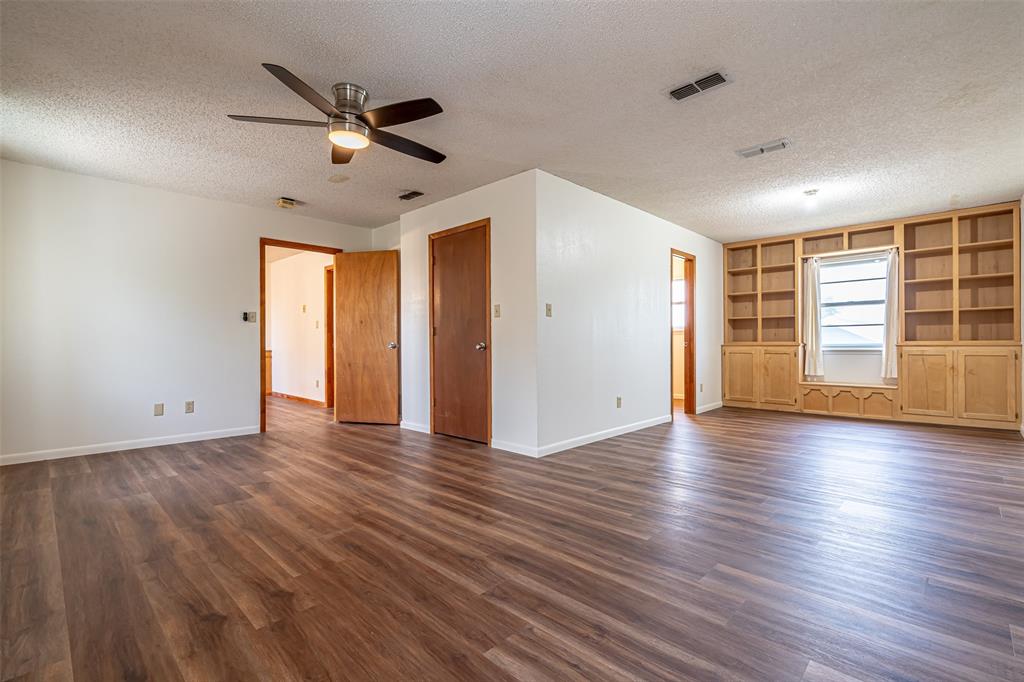 501 Endora Dublin, TX 76446 - Photo 20 of 39 a view of an empty room with wooden floor and a window