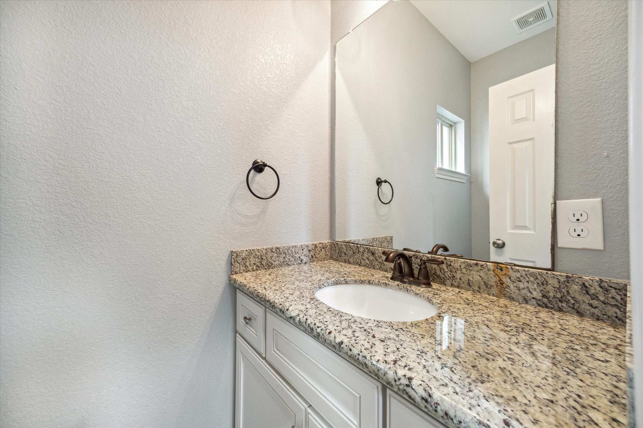 4916 Talina Way Houston, TX 77041 - Photo 14 of 25 a bathroom with a granite countertop sink and a mirror