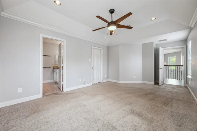 a view of a livingroom with a ceiling fan and window