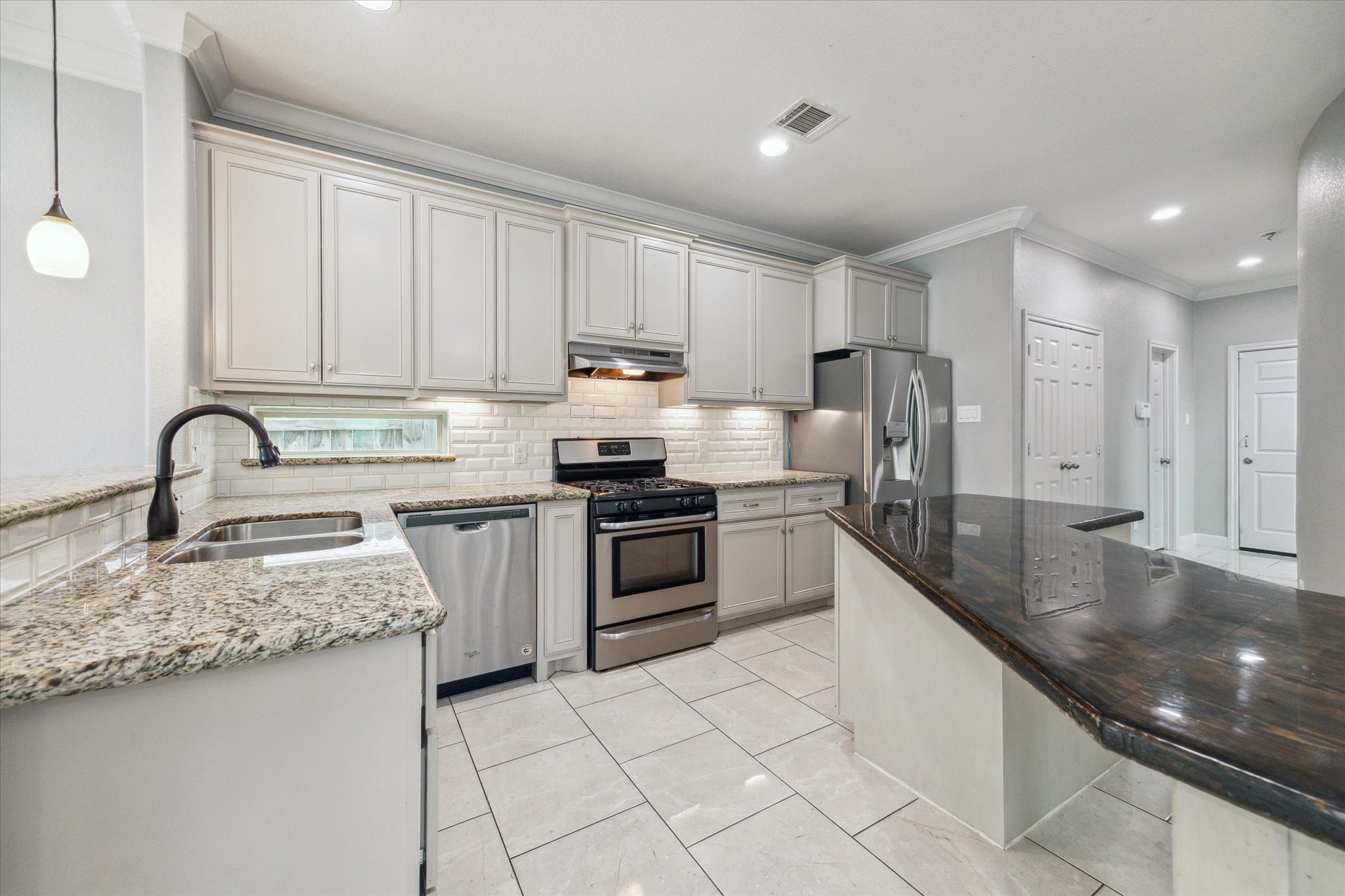4916 Talina Way Houston, TX 77041 - Photo 8 of 25 a kitchen with stainless steel appliances granite countertop a sink stove and cabinets