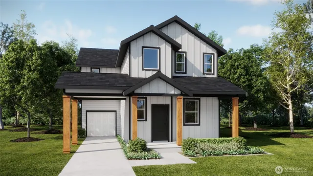 a front view of a house with a yard and trees