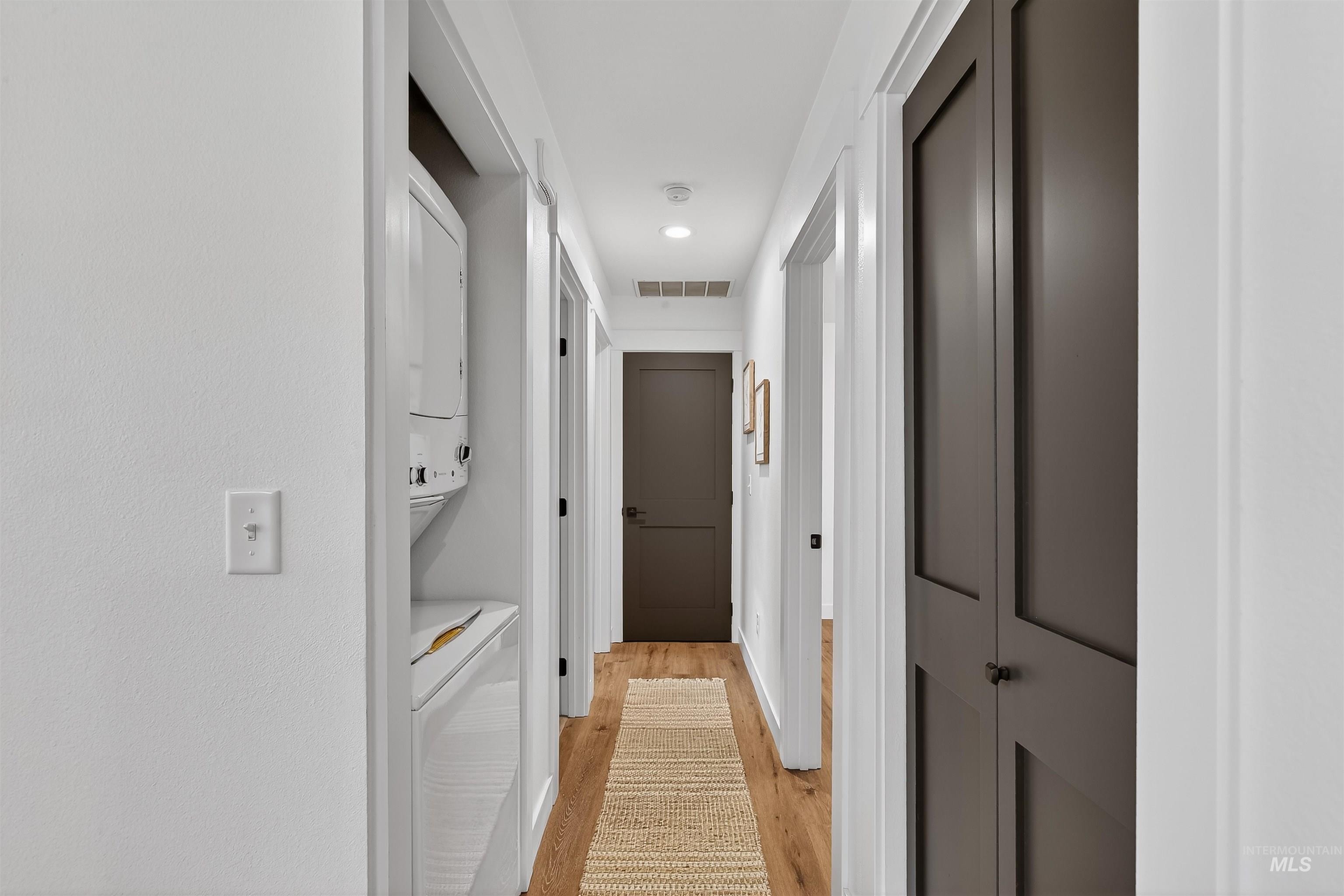 2922 Garfield Court Lewiston, ID 83501 - Photo 17 of 30 Hallway featuring light wood-style floors, stacked washer / drying machine, and recessed lighting
