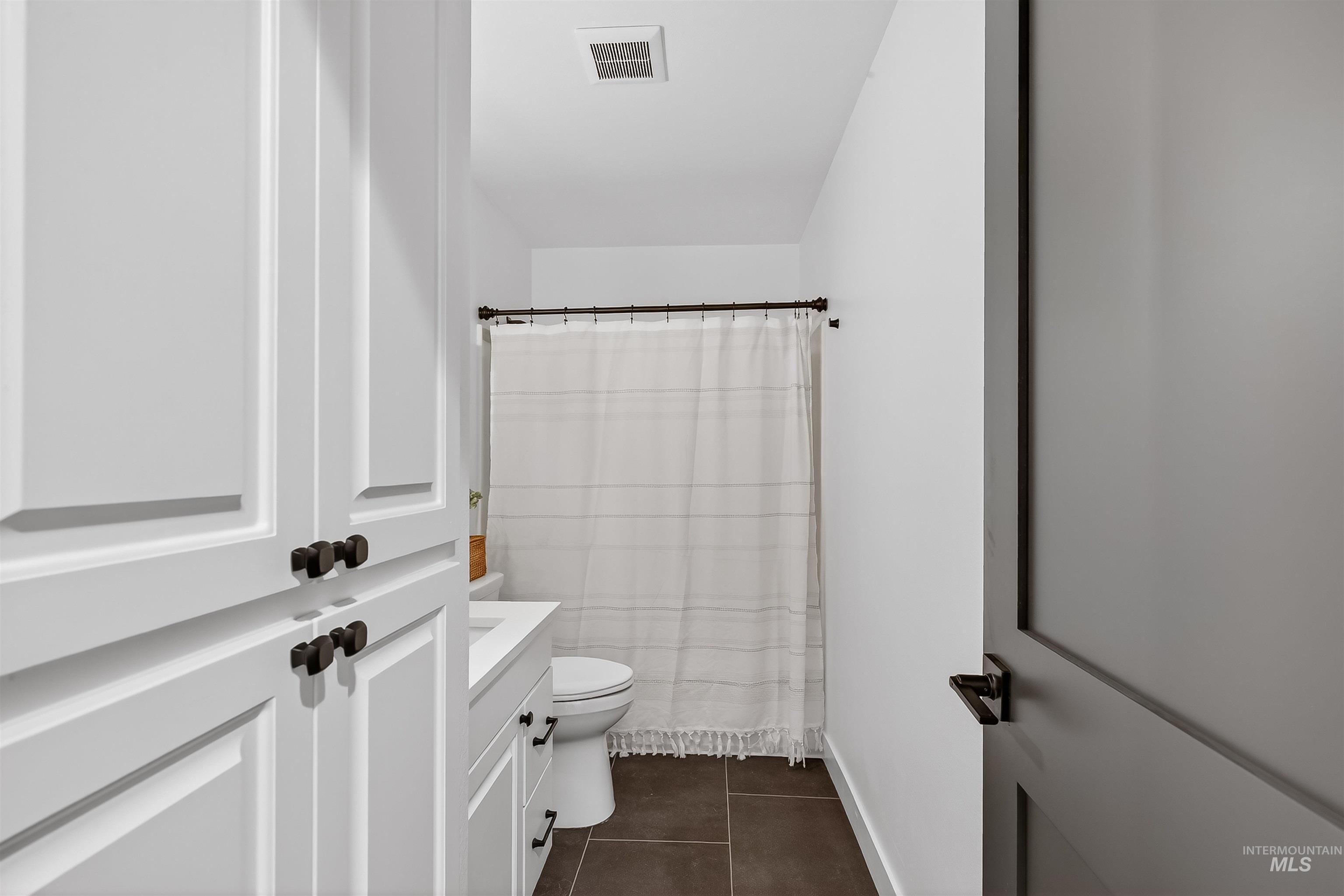 2922 Garfield Court Lewiston, ID 83501 - Photo 19 of 30 Full bathroom with vanity and dark tile patterned flooring