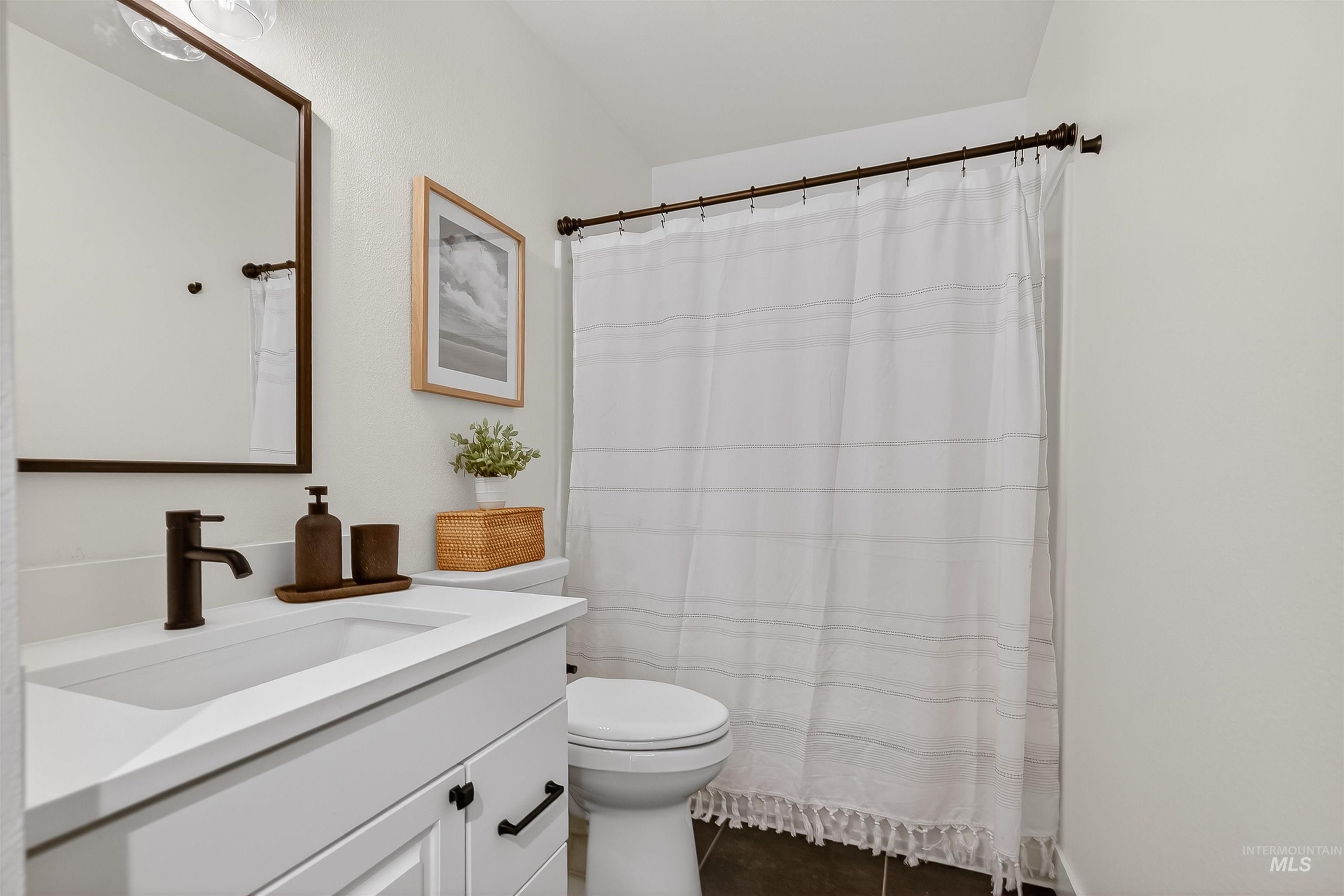2922 Garfield Court Lewiston, ID 83501 - Photo 21 of 30 Full bath featuring vanity, curtained shower, and dark tile patterned floors