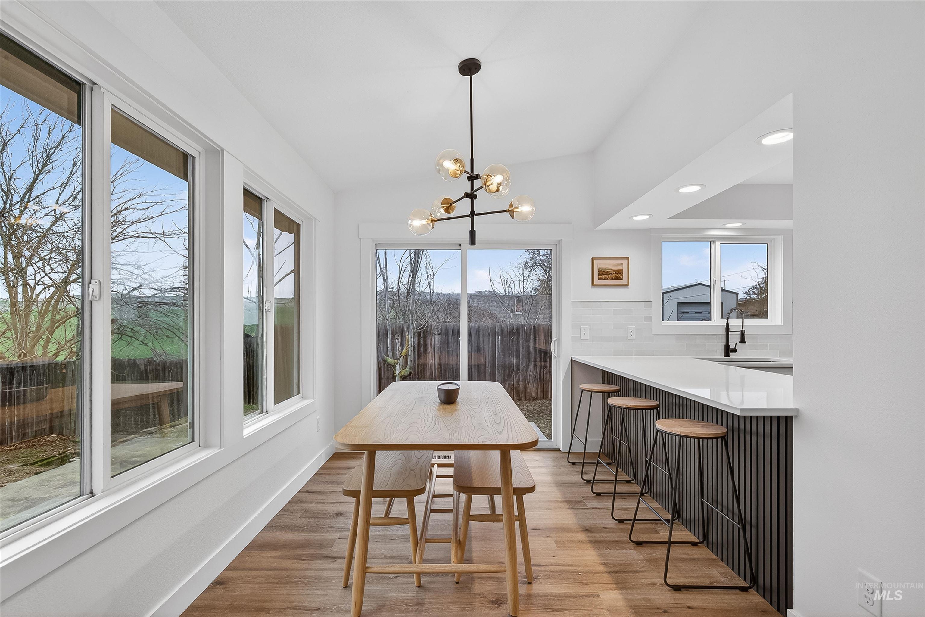 2922 Garfield Court Lewiston, ID 83501 - Photo 3 of 30 Dining space featuring light wood finished floors, recessed lighting, a chandelier, and lofted ceiling