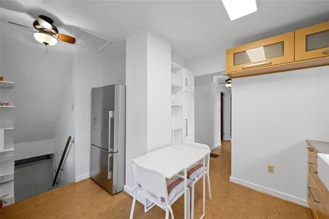 a kitchen that has a table and a refrigerator