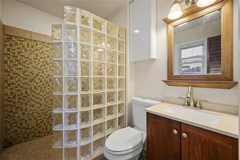 a bathroom with a sink a toilet and shower