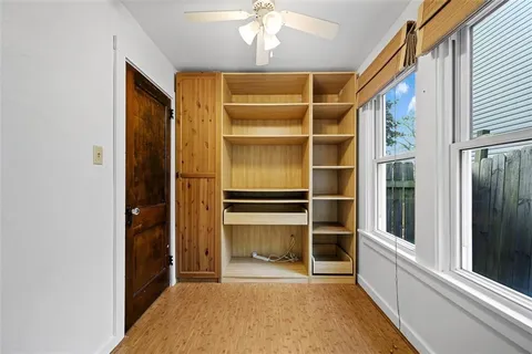 a view of walk in closet with empty racks