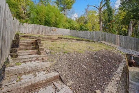 a view of a yard with a house in the background