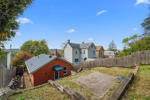 a view of house with backyard