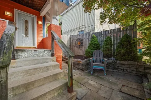 an aerial view of a house with a yard and trees
