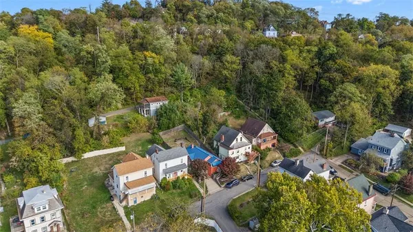 an aerial view of a house with a yard