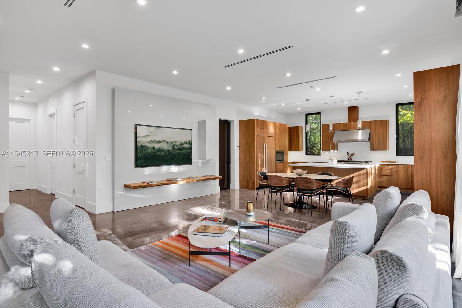 3232 Emathla Street Miami, FL 33133 - Photo 25 of 38 a living room with lots of furniture and view of kitchen