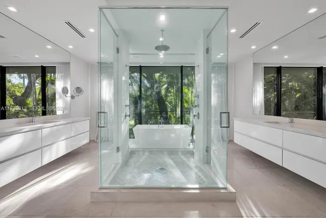 a large white bathroom with a large tub and shower