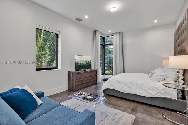 a bedroom with furniture and a window