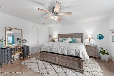 a hallway with washer dryer and wooden floor
