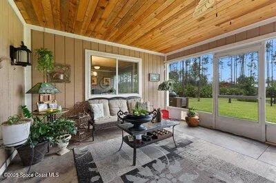 a view of a backyard with plants and lake view