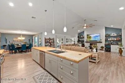 a kitchen with stainless steel appliances a white cabinet and a refrigerator