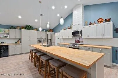 a view of a dining room with furniture a chandelier and wooden floor