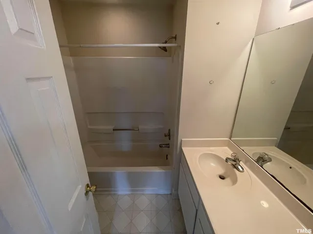 a bathroom with a tub sink and shower