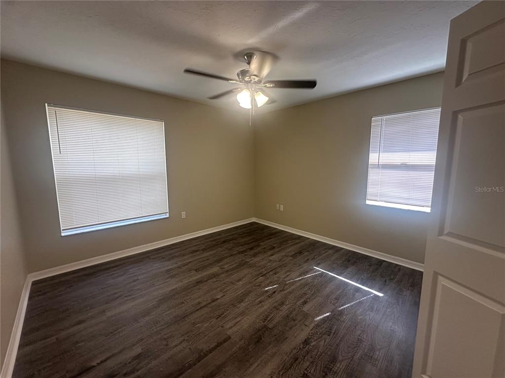 4495 Diamond Circle East Sarasota, FL 34233 - Photo 13 of 21 a view of empty room with wooden floor and fan