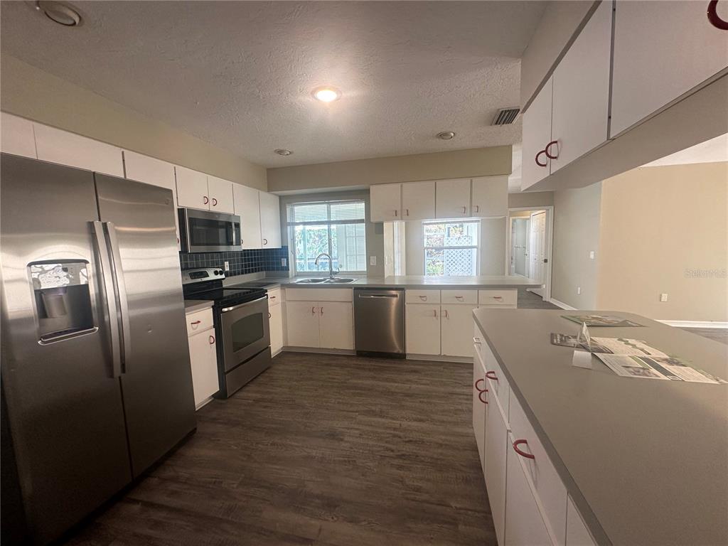 4495 Diamond Circle East Sarasota, FL 34233 - Photo 5 of 21 a kitchen with a sink refrigerator and window