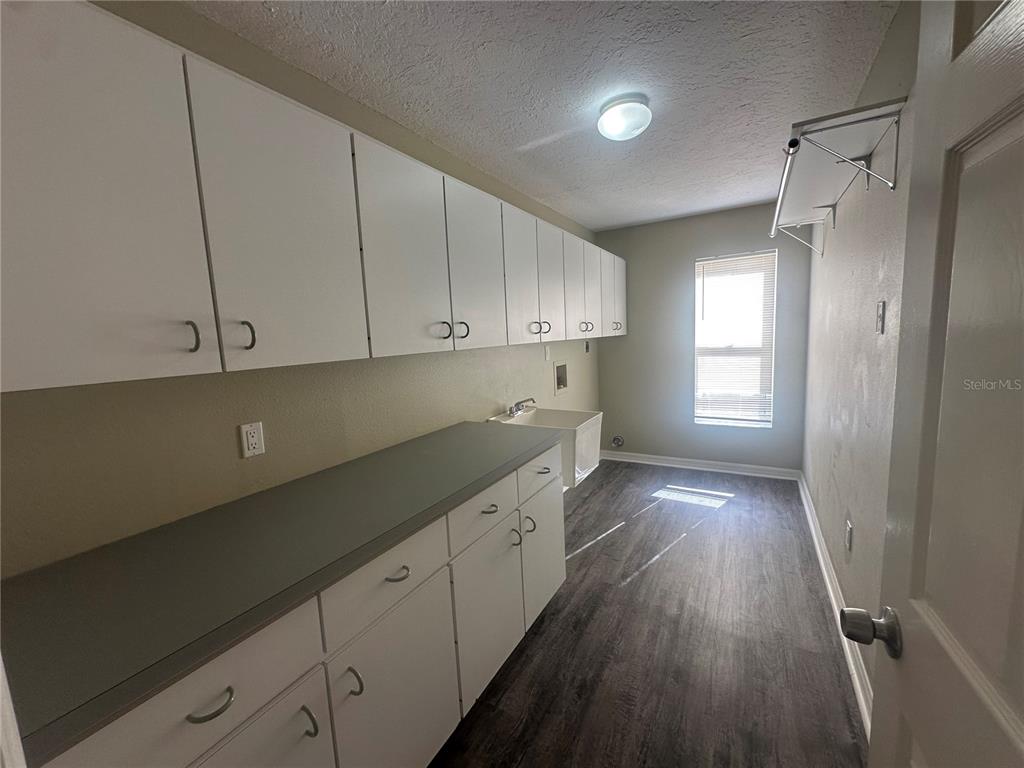 4495 Diamond Circle East Sarasota, FL 34233 - Photo 7 of 21 a kitchen with cabinets and wooden floor