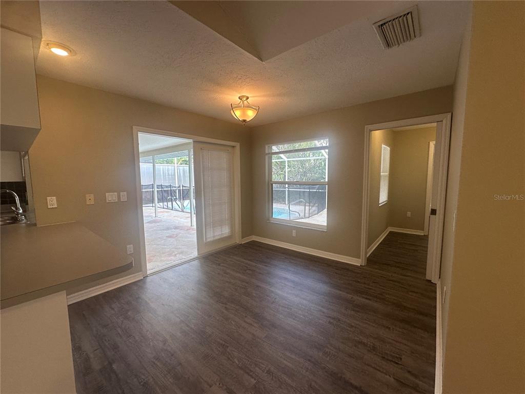 4495 Diamond Circle East Sarasota, FL 34233 - Photo 8 of 21 an empty room with wooden floor and windows