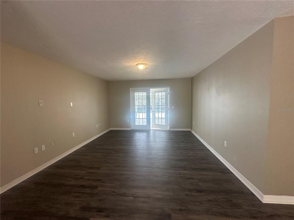 4495 Diamond Circle East Sarasota, FL 34233 - Photo 9 of 21 a view of wooden floor and windows in a room