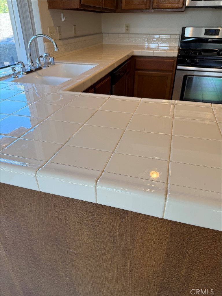 29 Cerrito Irvine, CA 92612 - Photo 11 of 11 a kitchen with granite countertop a stove and a refrigerator