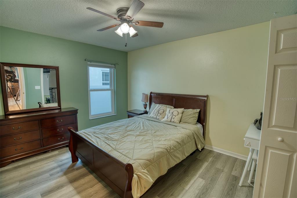 4303 Orange Ridge Court Valrico, FL 33596 - Photo 13 of 40 a bedroom with a bed and a large window