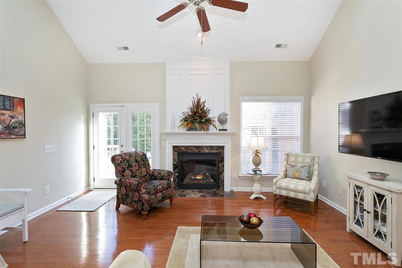 5110 Kate Denson Way Raleigh, NC 27612 - Photo 12 of 30 a living room with furniture a flat screen tv and a fireplace