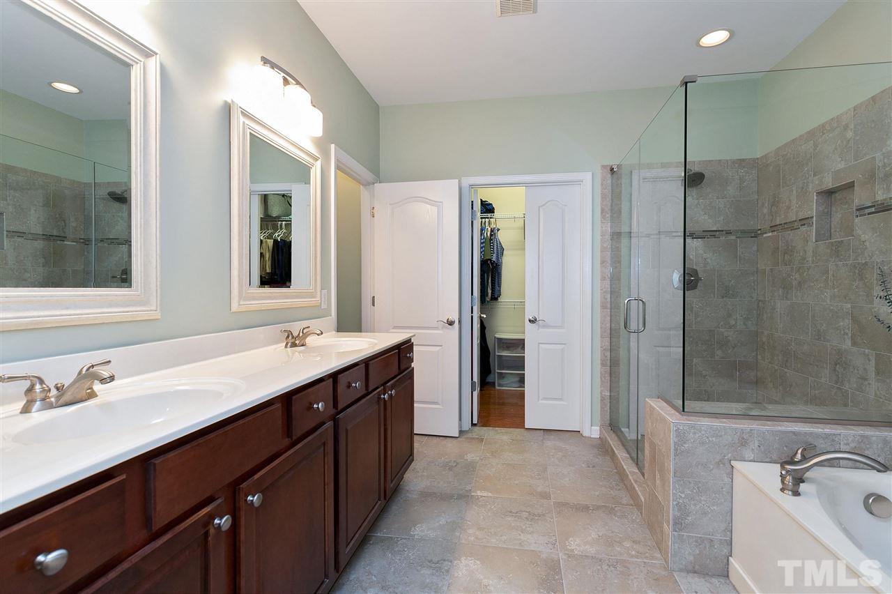 5110 Kate Denson Way Raleigh, NC 27612 - Photo 15 of 30 a spacious bathroom with a shower sink and mirror
