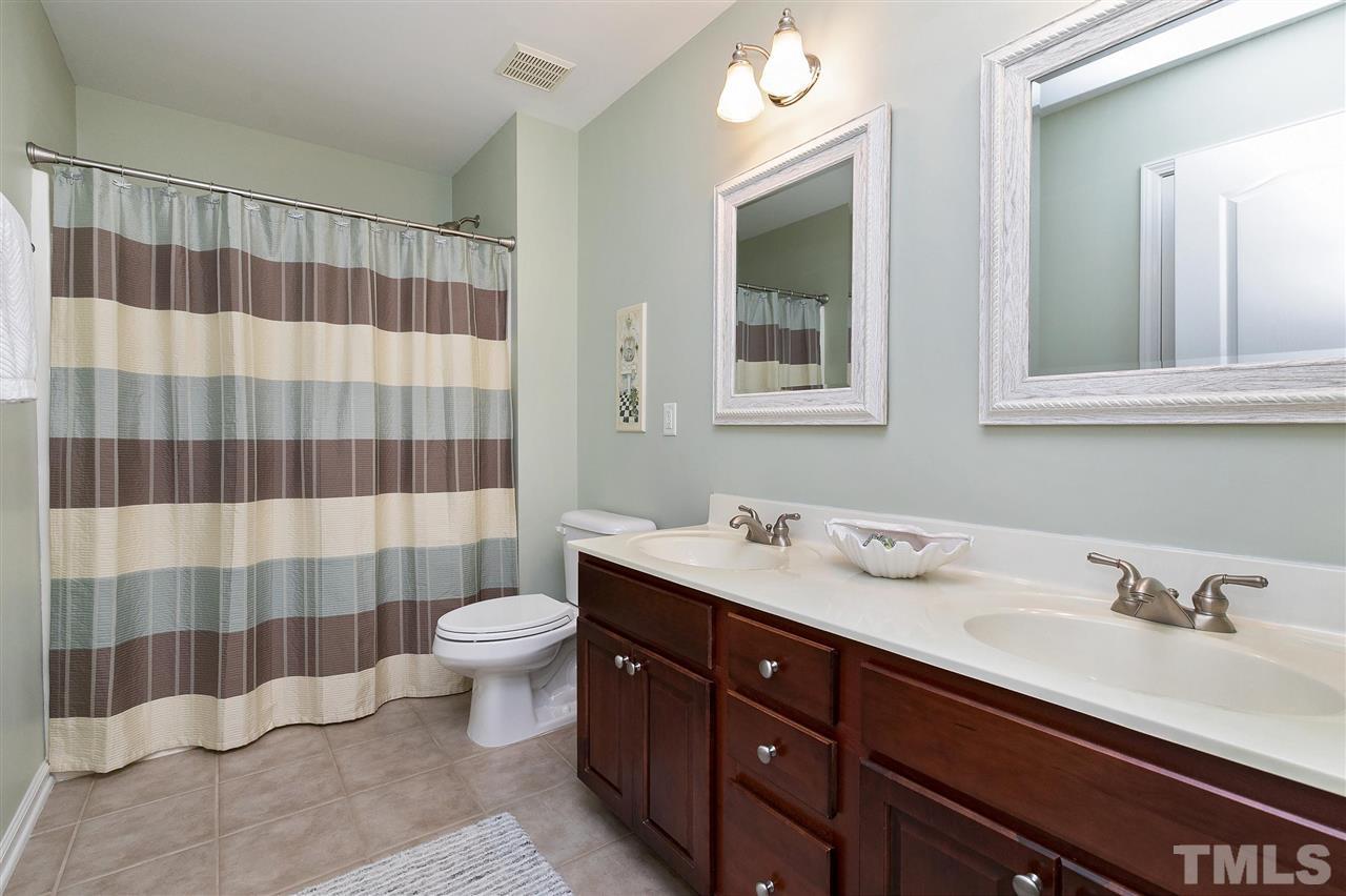5110 Kate Denson Way Raleigh, NC 27612 - Photo 22 of 30 a bathroom with a double vanity sink toilet and shower