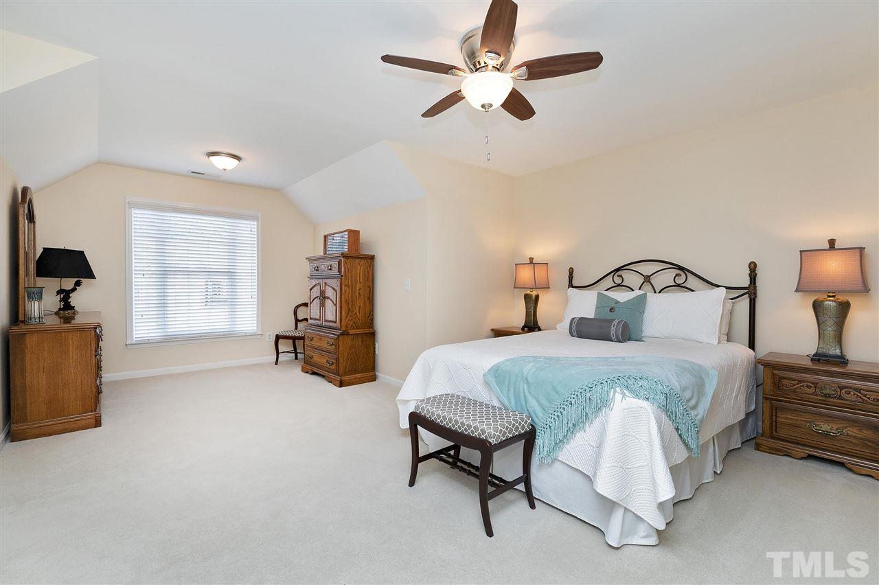 5110 Kate Denson Way Raleigh, NC 27612 - Photo 23 of 30 a bedroom with bed and a large mirror