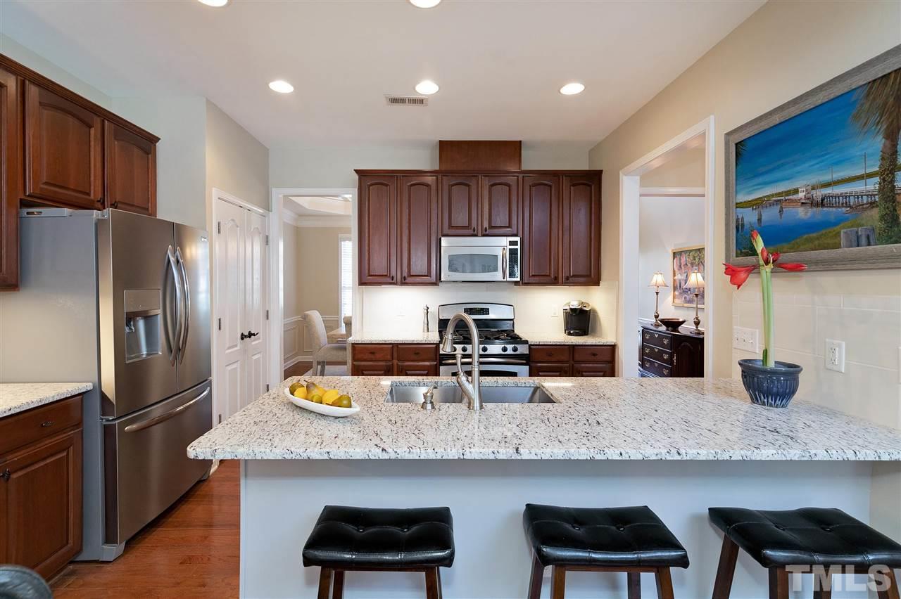 5110 Kate Denson Way Raleigh, NC 27612 - Photo 6 of 30 a kitchen with granite countertop stainless steel appliances and wooden cabinets