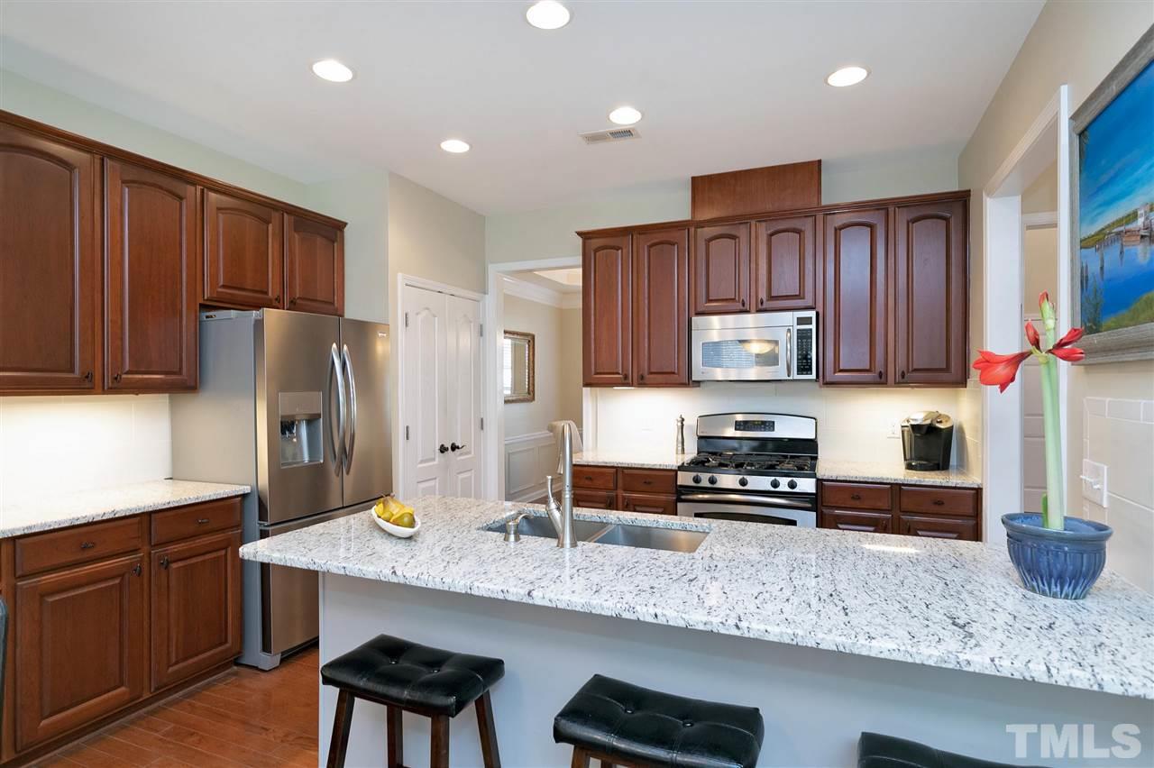 5110 Kate Denson Way Raleigh, NC 27612 - Photo 7 of 30 a kitchen with stainless steel appliances granite countertop a refrigerator sink and cabinets